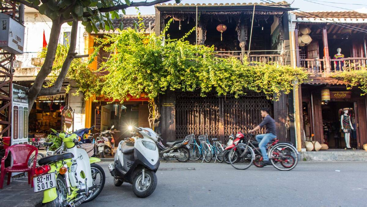 Old wooden shops line the streets in Hoi An.
