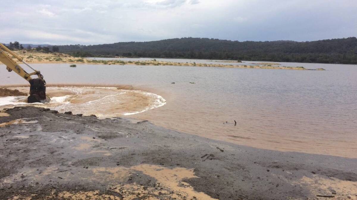 Council workers help open Wallagoot Lake to the sea in 2015. Picture: Bega District News
