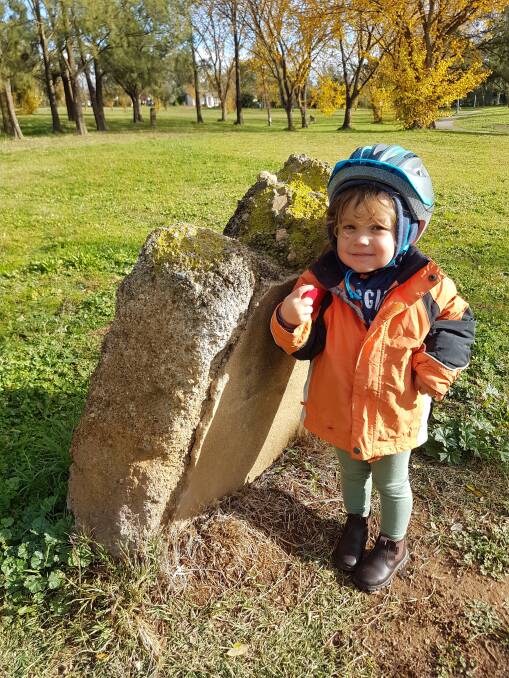 Three-year-old Lachlan Bush with a foundation stone from Cranleigh that was relocated to this location near the Macgregor Primary School in 1986. Picture: Justin Bush