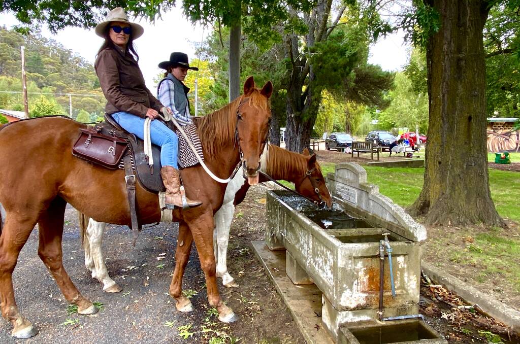 Jo Brissenden and niece Claire Hall stop their horses for a drink at the Captains Flat water trough. Picture by Tim the Yowie Man