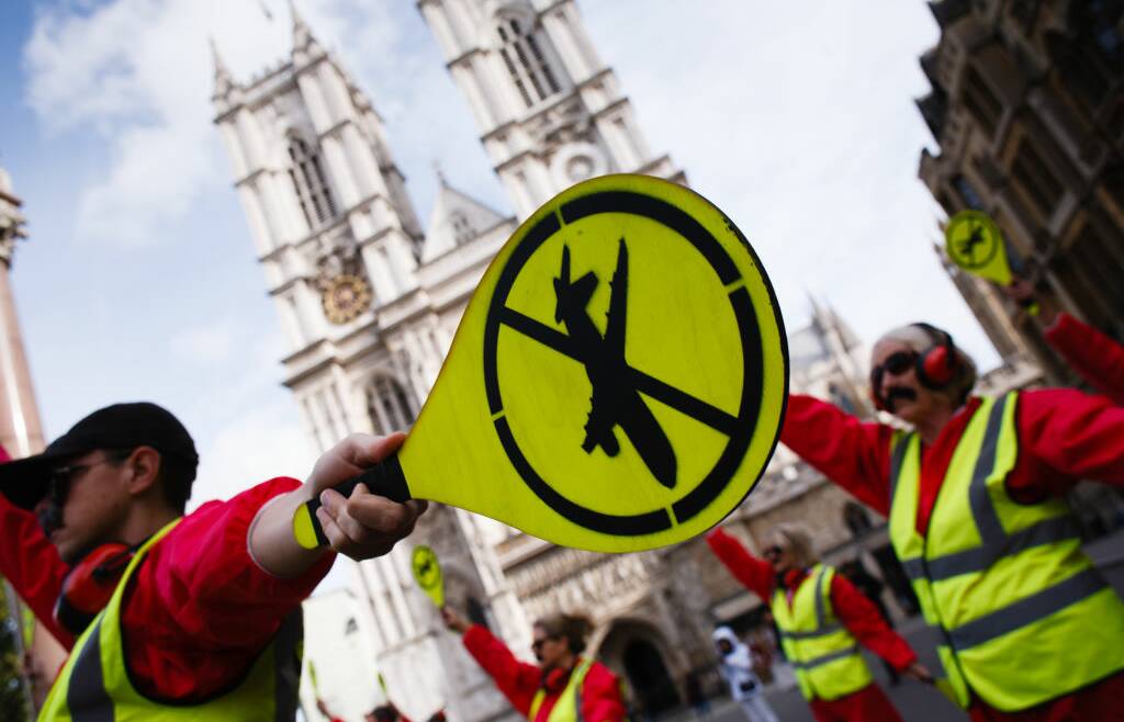 Members of climate change activist movement Extinction Rebellion bear anti-aviation logos during a demonstration in London earlier this year. Pictures: Getty Images