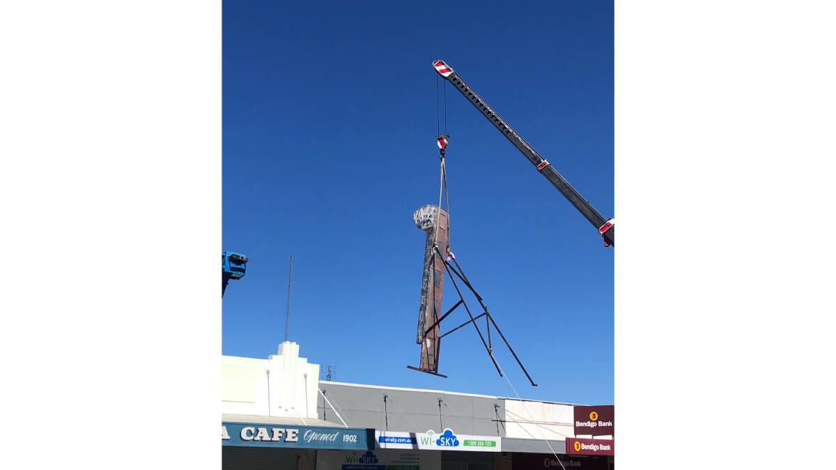 The Niagara Café neon sign being craned off the roof of the Gundagai institution for restoration. Picture: Luke Walton