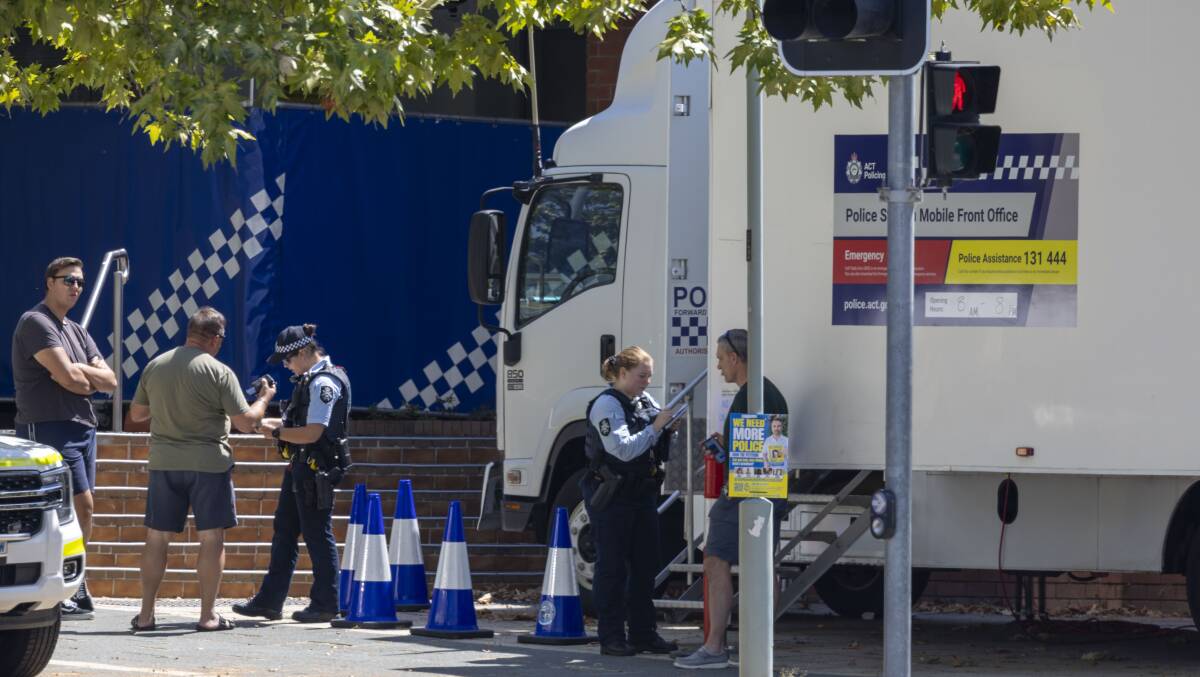 Not quite business-as-usual policing from a truck parked out front of the contaminated JESC in Gungahlin. Picture by Gary Ramage 
