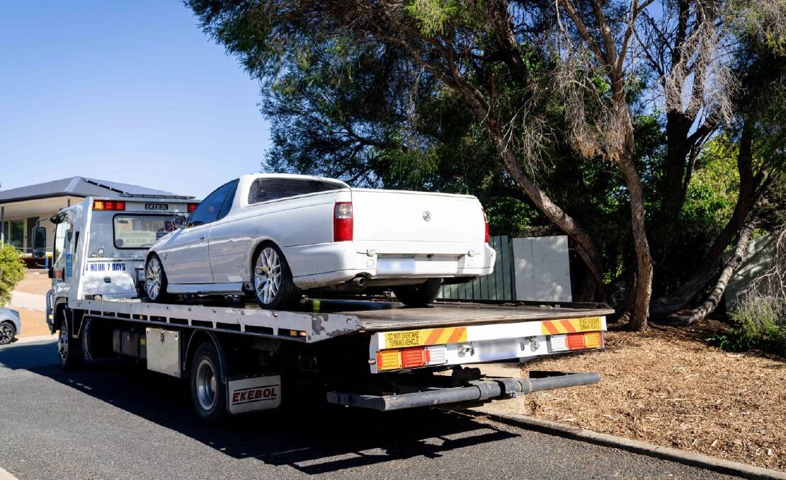 A Commodore utility seized by police is trucked away on a flatbed. Picture: ACT Policing 