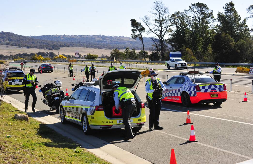 ACT and NSW police set up on Lanyon Drive. Picture: Dion Georgeopoulos.