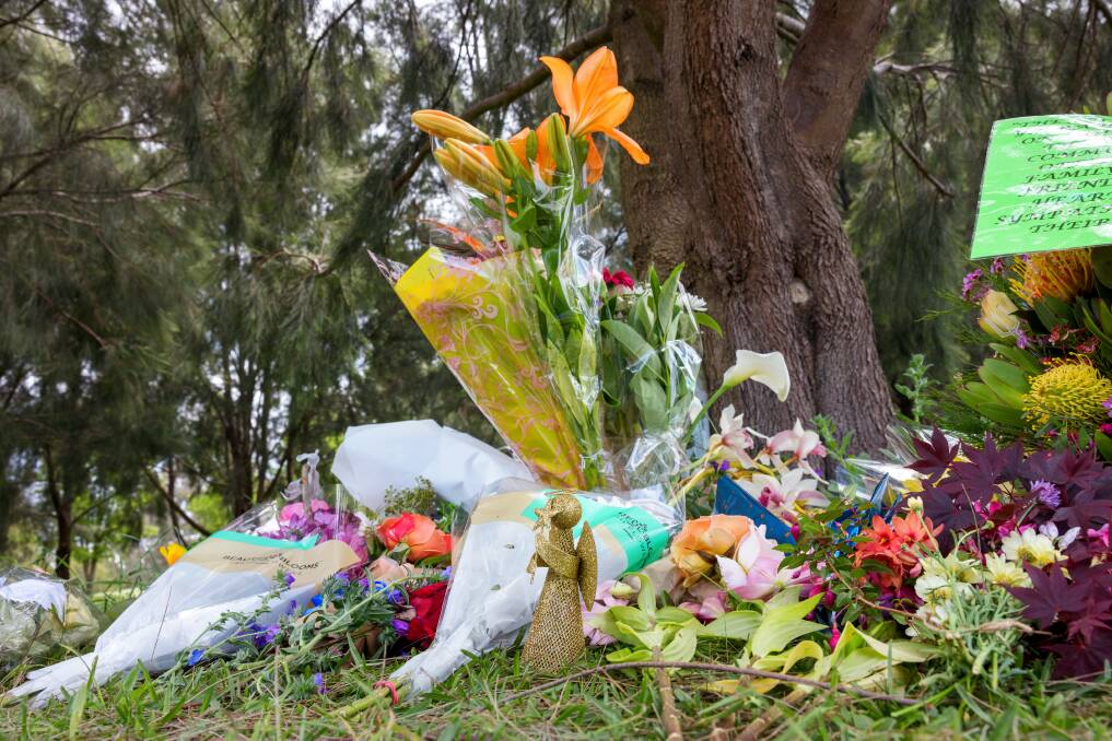 Flower tributes have been placed by Yerrabi Pond near where the bodies of the mother and children were found on the weekend. Picture by Sittihixay Ditthavong