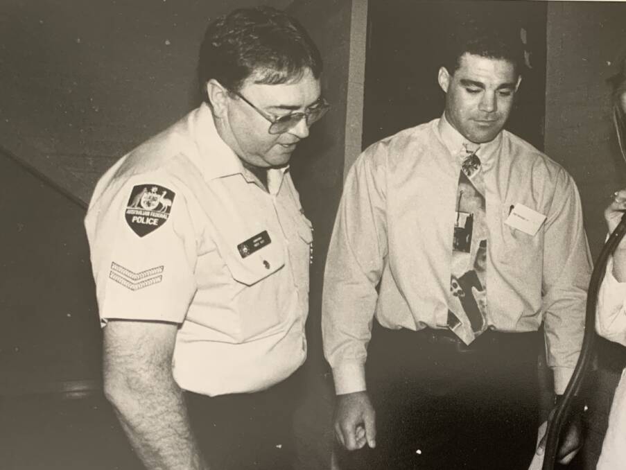 Constable Mick Guy and Mal Meninga watch on as Narrabundah College student Sally Turner tests out the new police breathalyser equipment in 1982, as part of a road safety program for students. Picture: Gary Schafer