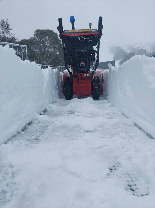 Clearing snow from the Merritt's deck at Thredbo: Picture: Thredbo