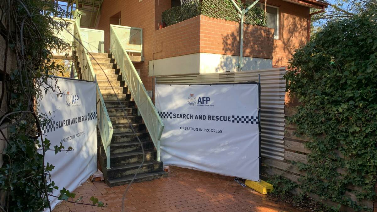 The rear entry to the Phillip unit complex, with police screens in place. Picture: Peter Brewer