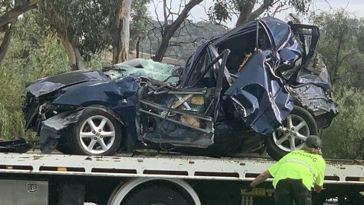 The victim's Corolla after it had been rammed from behind, flipped over a guardrail and into a tree on the Monaro Highway. Picture: Julia Kanapathippillai