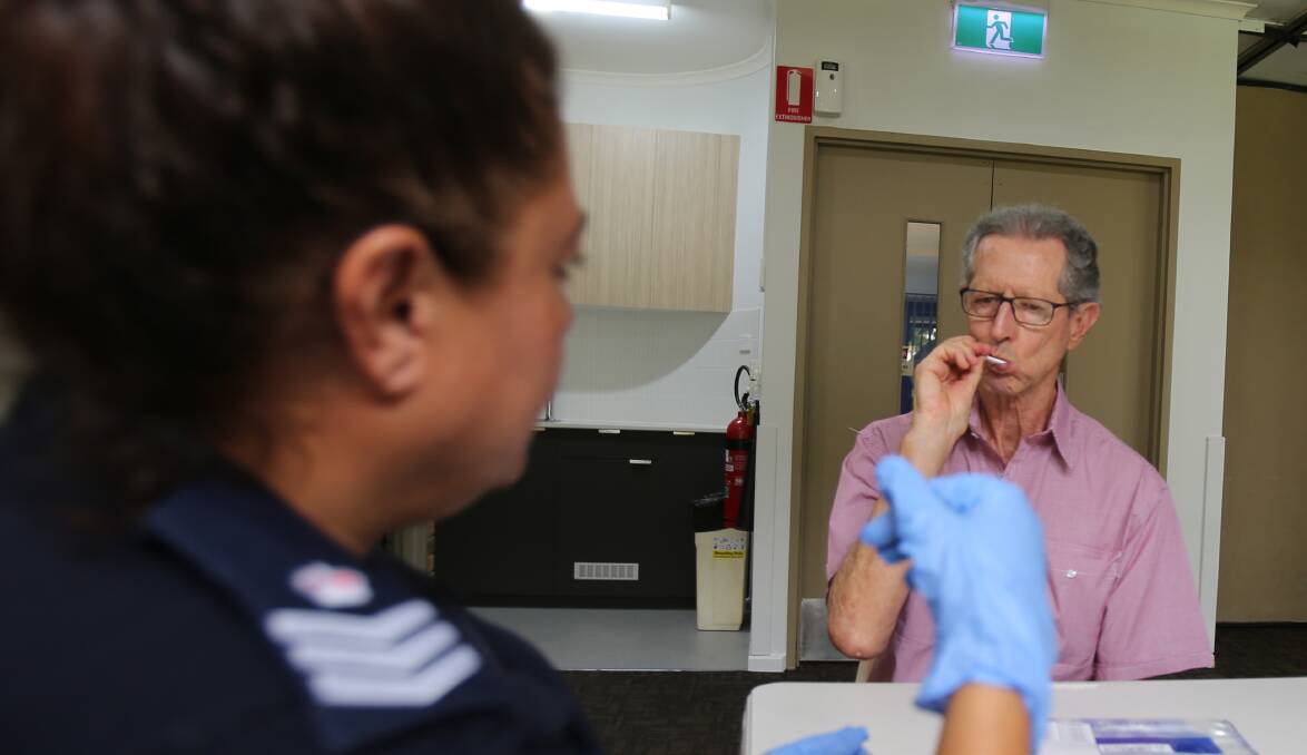 A NSW police officer from the Missing Persons team collects a DNA buccal swab during a previous 'pop-up' centre. Picture: NSW Police