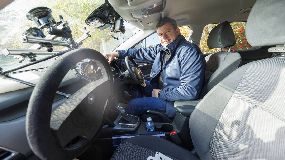 Seeing Machines boss Paul McGlone inside one of the test rig cars at the company's Fyshwick headquarters. Picture by Keegan Carroll