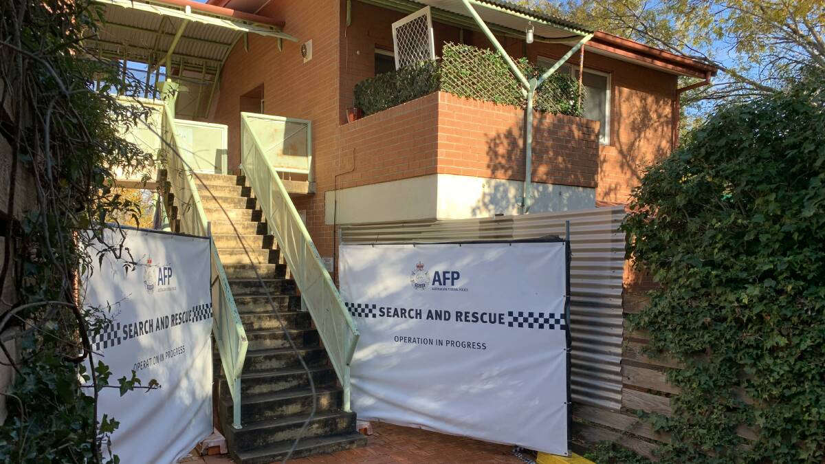 The back entrance to the Phillip townhouse, with police screens in place. Picture: Peter Brewer 