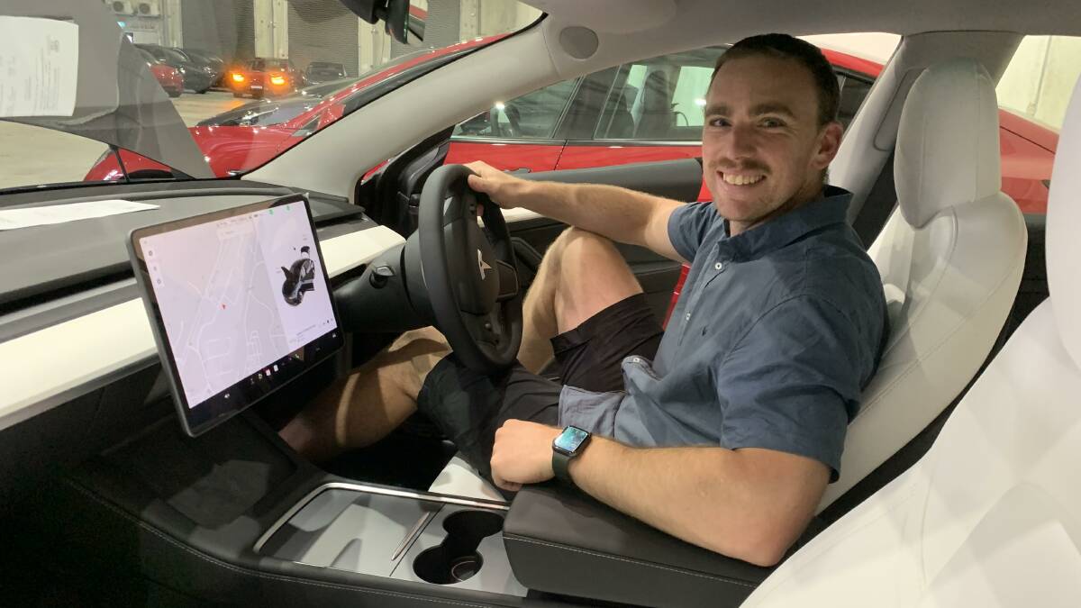 Despite the perfunctory handover, Keegan Carroll was still a very happy Model 3 customer. Picture by Peter Brewer 