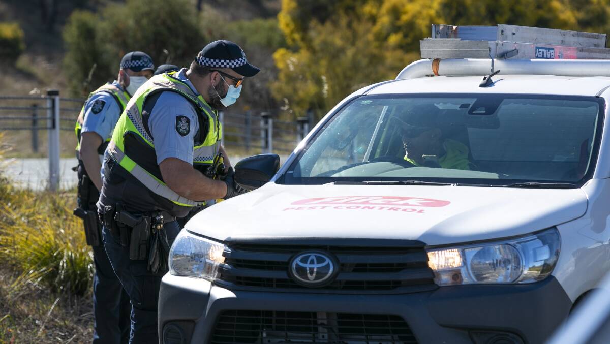 ACT Policing check driver details on Friday. Picture: Keegan Carroll