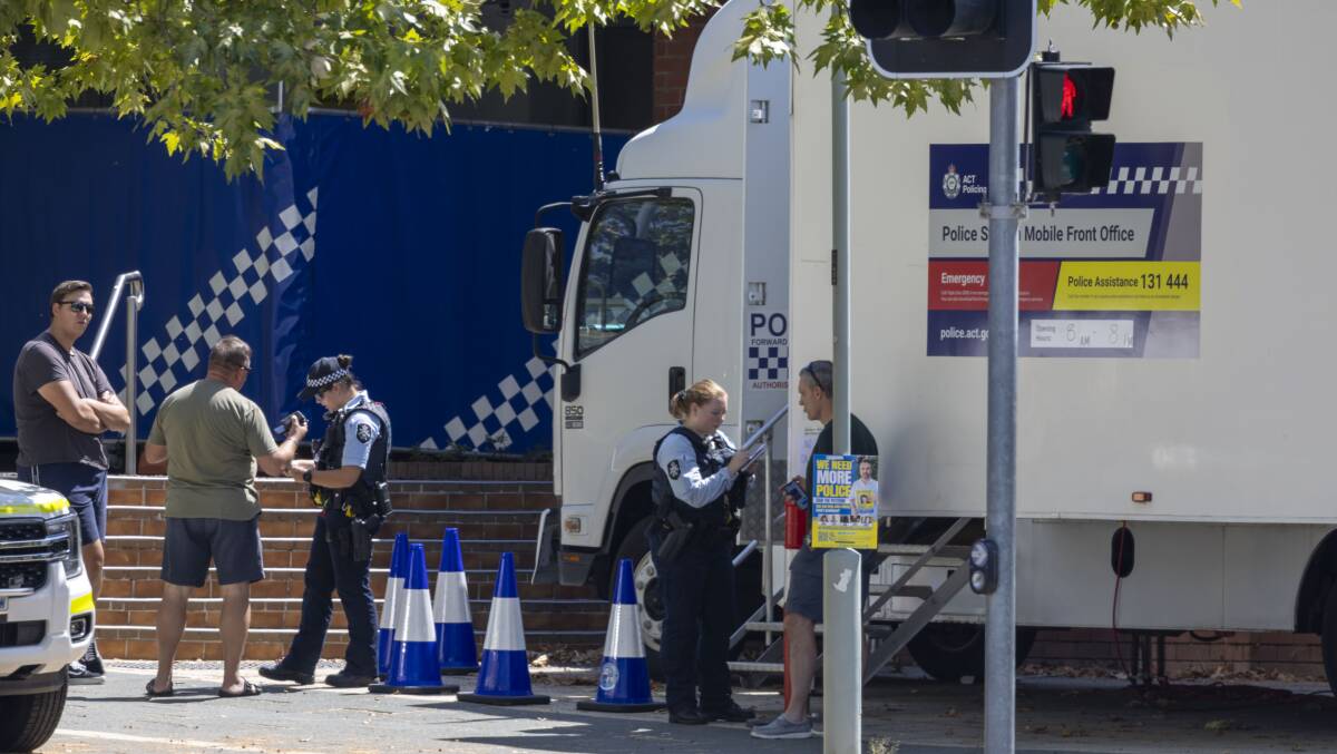 A temporary front office, using a police truck, crime scene barriers and a portaloo, was tried at Gungahlin, then quietly abandoned. Picture by Gary Ramage 