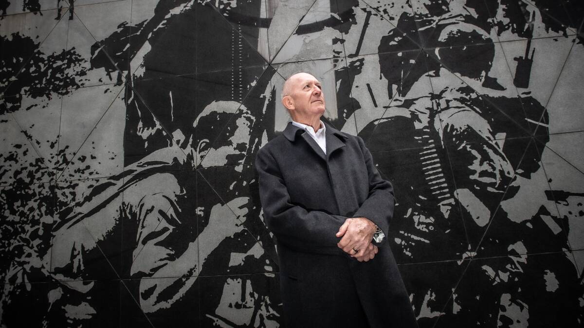 Framed by the memorial's striking image of Australian soldiers preparing to be airlifted from Phuoc Tuy Province in August 1967, Sir Peter Cosgrove pauses to reflect. Picture by Karleen Minney
