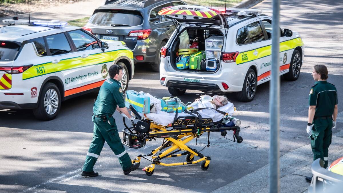 An ANU student is wheeled to an ambulance after the attack. Picture by Karleen Minney