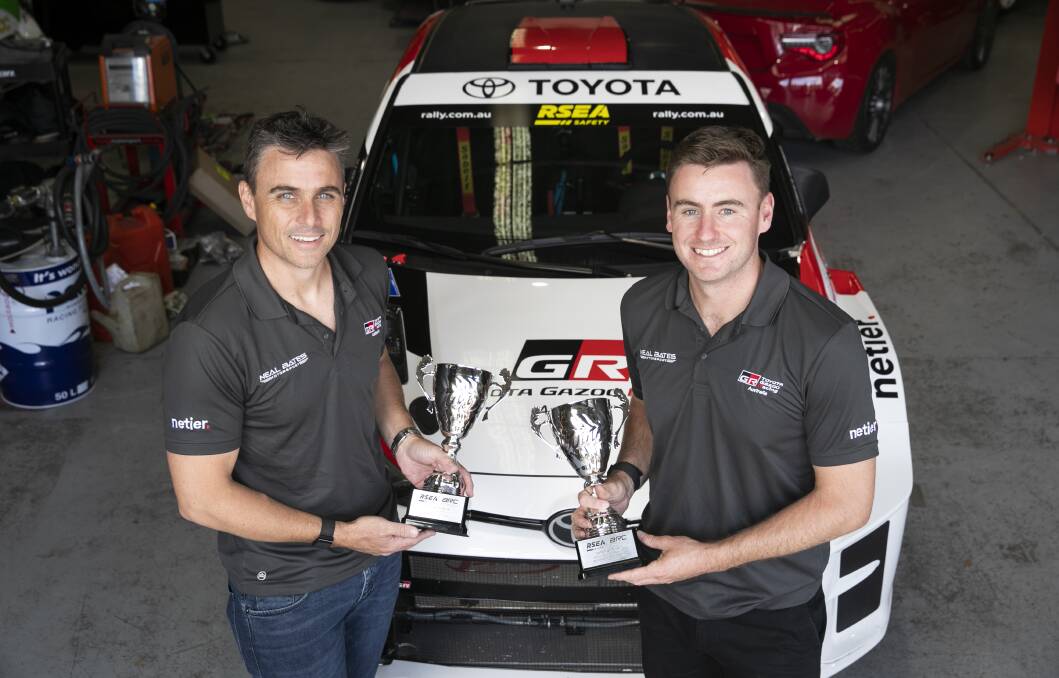 John McCarthy, left, and Harry Bates with their championship trophies. Picture: Supplied