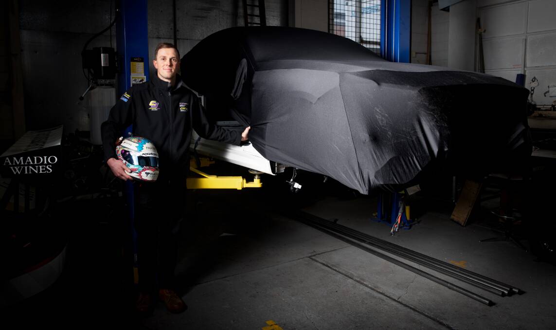 Canberra race driver Cameron Hill with his secret project for next year's Bathurst six-hour race. Picture: Sitthixay Ditthavong