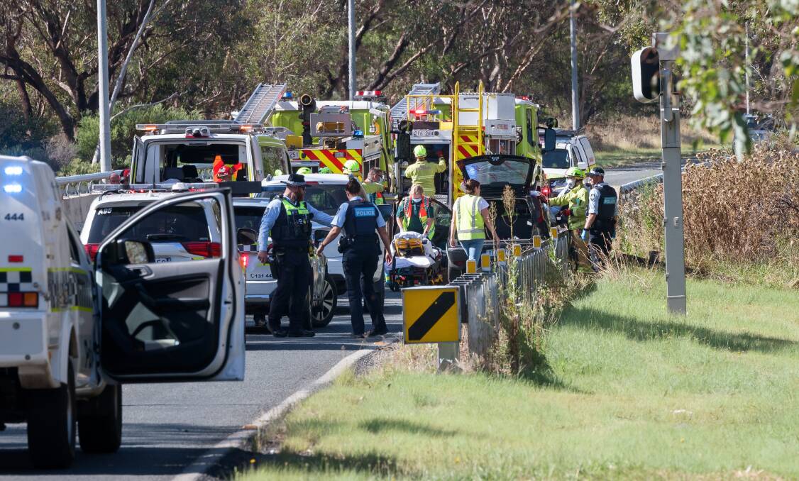 Ambulance officers prepare to take a patient to hospital after a single vehicle incident on the Tuggeranong Parkway. Picture by Sitthixay Ditthavong