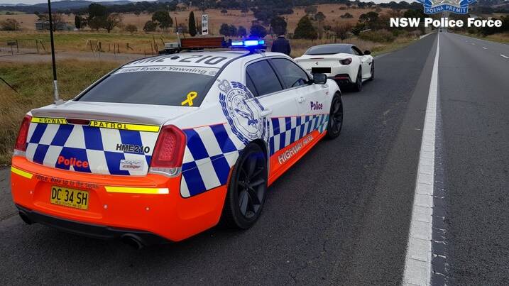 The NSW Police Highway Patrol with the Ferrari on the Hume Highway on Friday morning. Picture: NSW Police