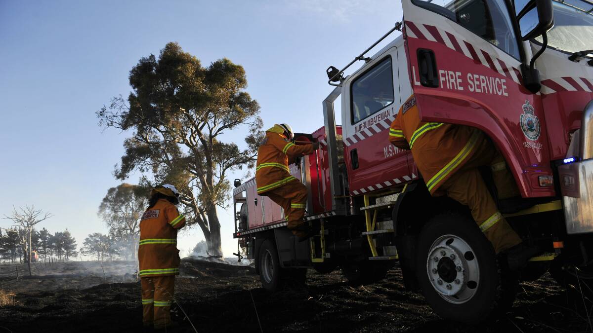 A Rural Fire Service crews climbs down from their truck to check a fire is out. Picture by Jay Cronan 
