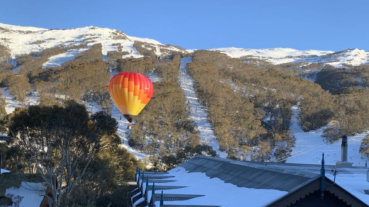 A hot air balloon floats down through the picturesque Thredbo valley. Picture by Peter Brewer 