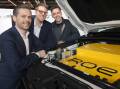 Roev's Lenny Cucksley, Noah Wasmer and Paul Slade, with their vehicle-to-grid battery pack under the bonnet of a conventional-looking Toyota Hilux. Picture: James Croucher