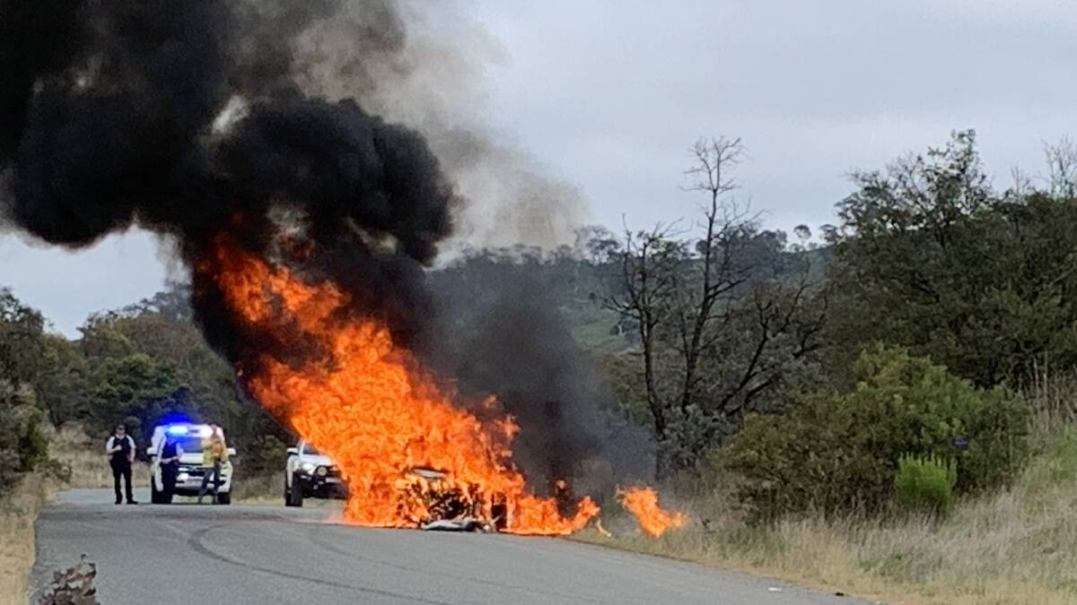 A stolen Mercedes burns to the ground near Eaglehawk as police wait for the fire service. Picture by Peter Brewer 