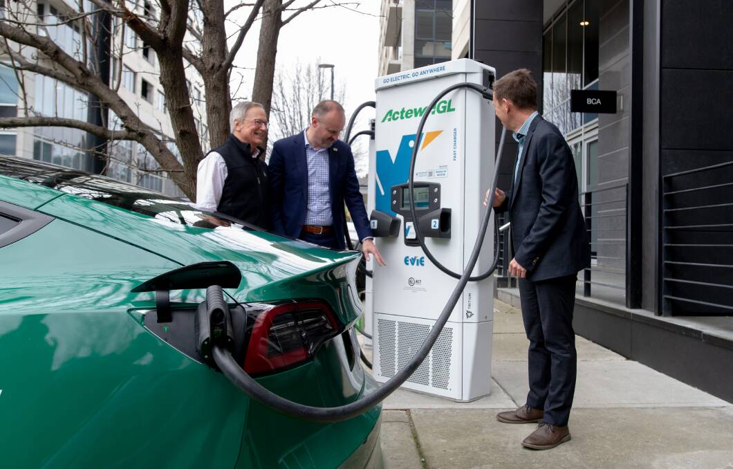 Evie Networks' Chris Mills, ACT Chief Minister Andrew Barr and Climate Change Minister Shane Rattenbury with the first of the new fast chargers in Barton. Picture: Elesa Kurtz