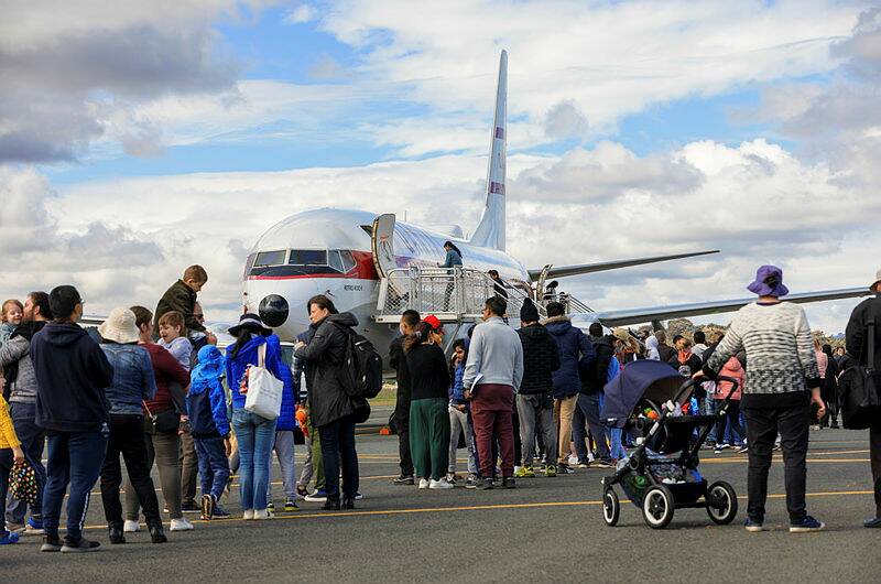 Crowds queued to take a walk-through the cabin of a Qantas jet at Canberra Airport Open Day. Picture: Keegan Carroll 