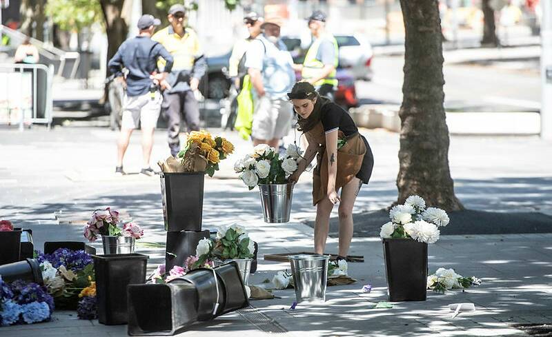 The film crew perfectly re-set the tubs of plastic flowers, for the fifth time, as yet another stunt scene is filmed on Canberra's city streets. Picture: Karleen Minney. 
