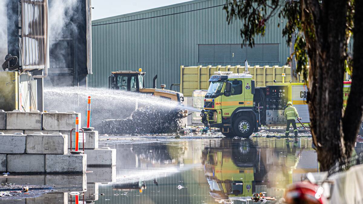 The day after the fire ignited, firefighters were still hosing down the smouldering material. Picture by Karleen Minney