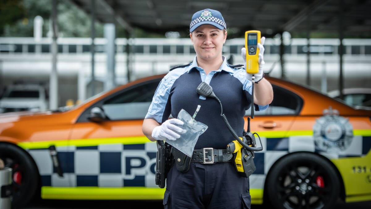 Senior Constable Amy Slaviero holding the "blow in the bag" roadside testing test in one hand, and the latest digited "alcolizer" detection device in the other. Picture: Karleen Minney 