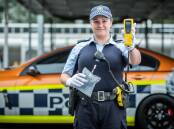 Senior Constable Amy Slaviero holding the "blow in the bag" roadside testing test in one hand, and the latest digited "alcolizer" detection device in the other. Picture: Karleen Minney 