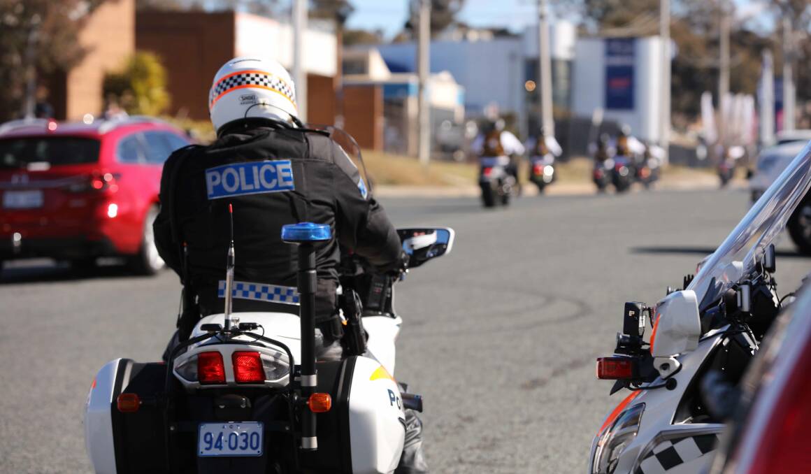 A police motorcyclist keeps watch as the Comancheros roll into Canberra. Picture supplied
