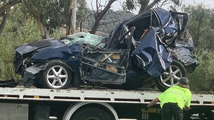 Lachlan Seary's Corolla after it had been rammed from behind, flipped over a guardrail and into a tree on the Monaro Highway. Picture: Julia Kanapathippillai