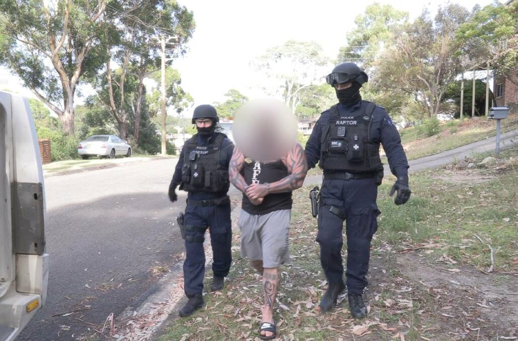 The bikie is taken into custody. Picture: NSW Police