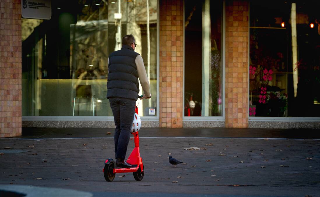 An unidentified rider scoots through Canberra without a helmet. Picture by Elesa Kurtz