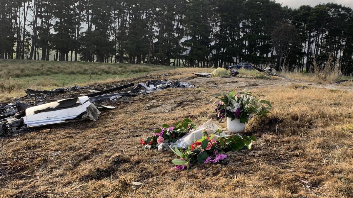 The bunches of flower tributes at the crash scene below the dam. Picture by Peter Brewer