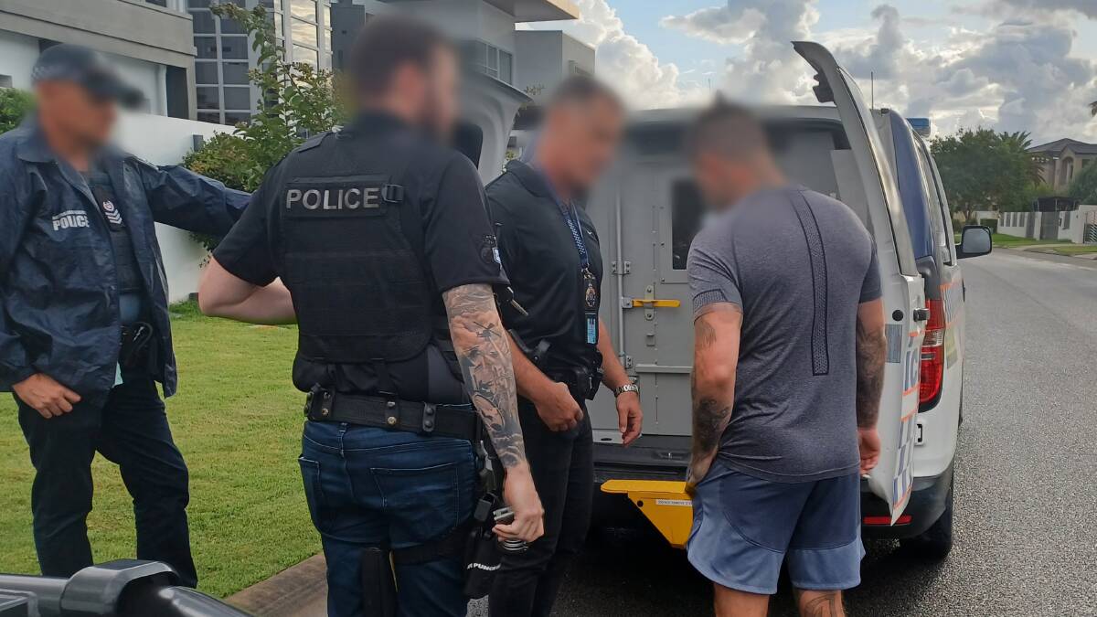 Allan Meehan, right, is arrested by Criminal Groups Squad detectives in Queensland on Thursday morning. Picture NSW Police 