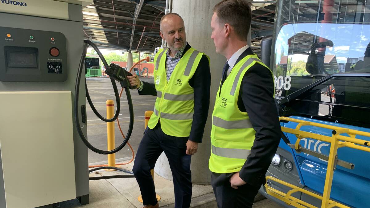 Chief Minister Andrew Barr and Transport Minister Chris Steel with a newly-installed charger at Tuggeranong depot. Picture by Peter Brewer 