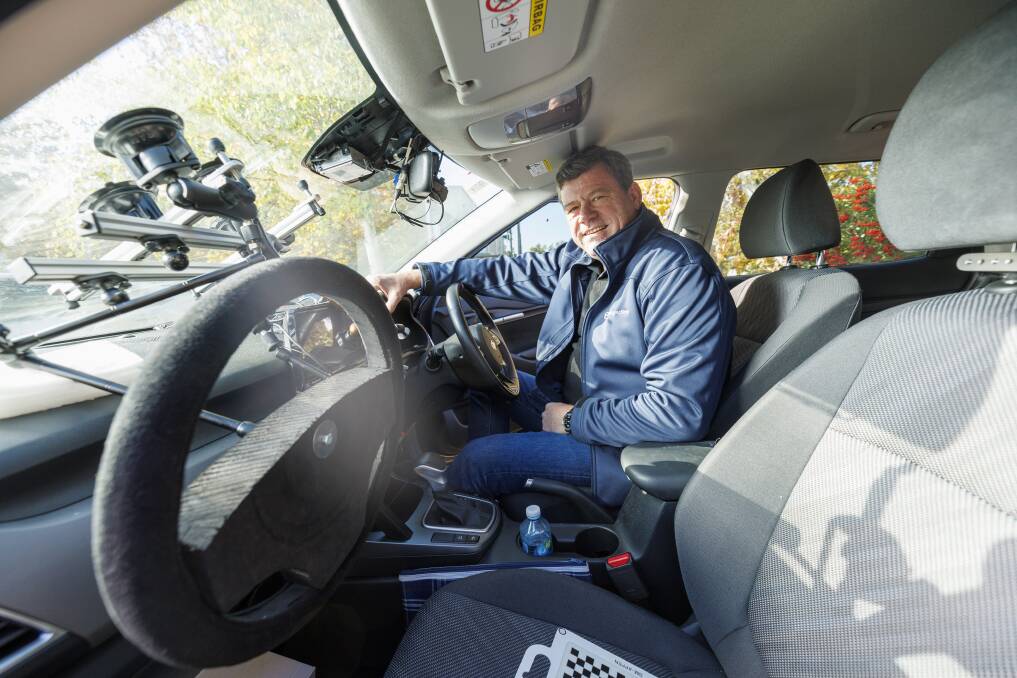 Seeing Machines' chief executive Paul McGlone in one of the company's test vehicles. Picture by Keegan Carroll 