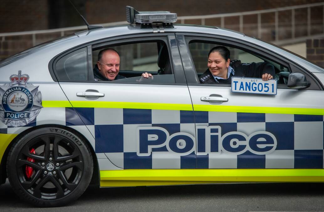 ACT Chief Police Officer Neil Gaughan and Superintendent Jo Brown, from the AFP museum, aboard the force's "retiring" V8 Commodore. Picture: Karleen Minney