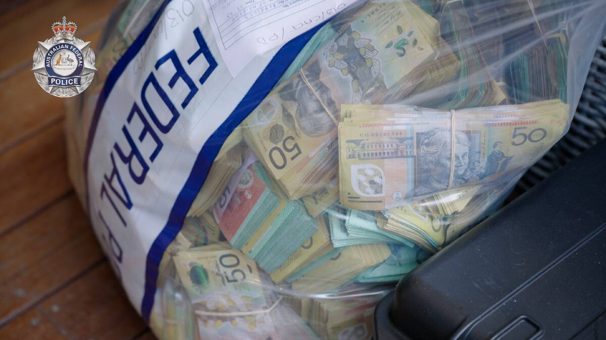 Around $1.5 million in cash, suspected to be proceeds from a money-laundering operation, was seized from a Canberra home last week. Picture: AFP