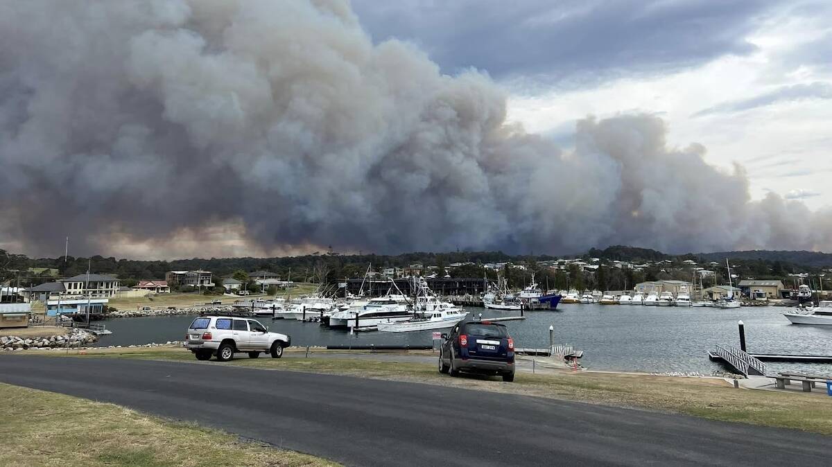 The huge cloud of smoke from the Coolaglolite Rd fire, near Cobargo, as seen from the Bermagui harbour on Tuesday afternoon. Picture by Ducky Radford
