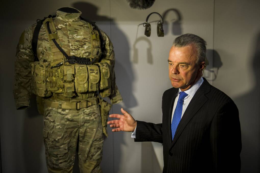 Former memorial director Brendan Nelson unveils Ben Roberts-Smith's uniform on display in the AWM in 2013. Picture by Rohan Thomson