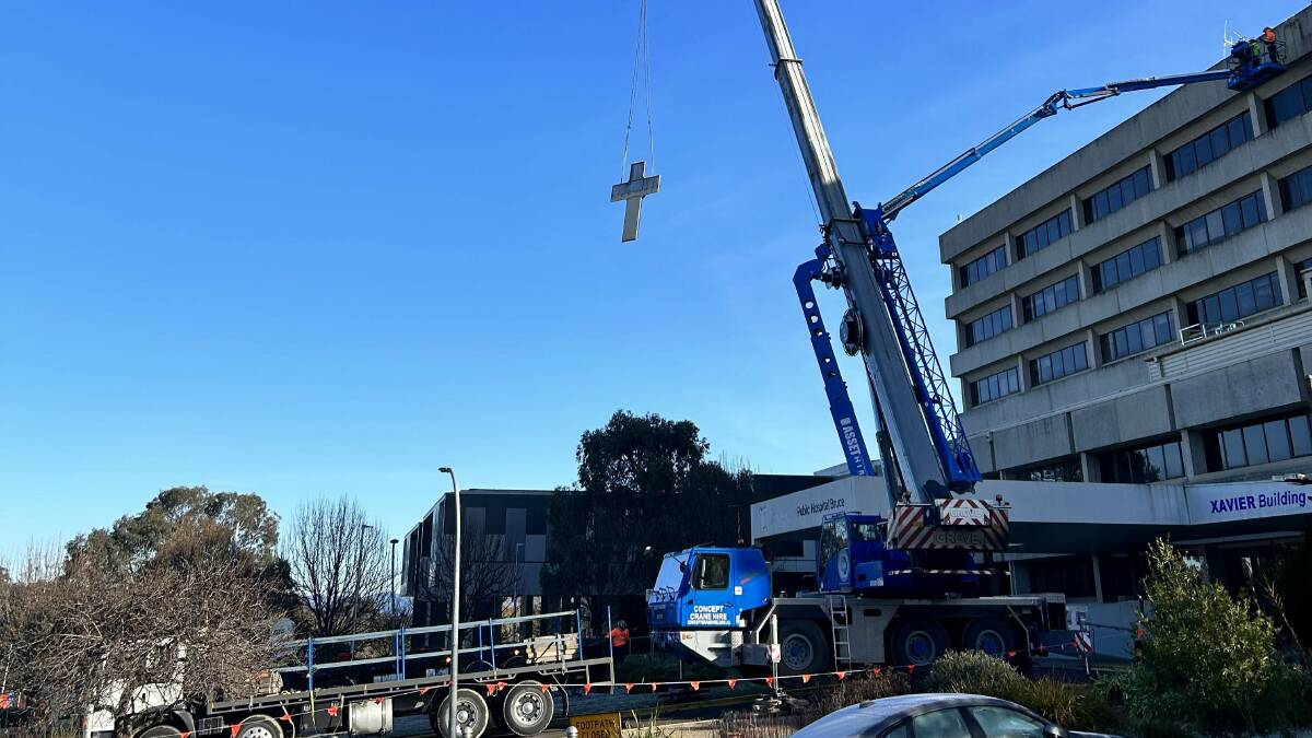 The cross being removed from the front of the hospital. Picture supplied