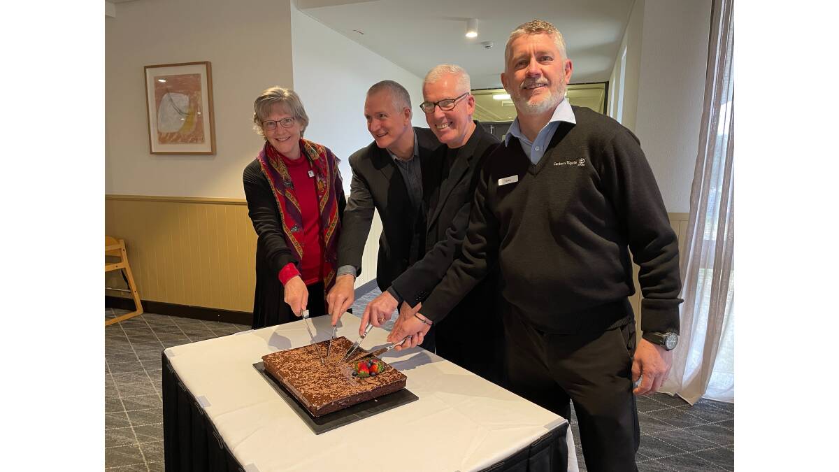 Vinnies Night Patrol volunteers (from left) Jenny, Greg Young, Tom McGuinness and Gary Bergkottee on Monday cut the cake celebrating the night patrol's 21st birthday. Picture by Megan Doherty